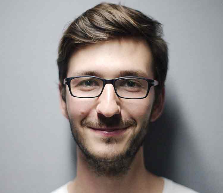 Man in a glasses is smiling